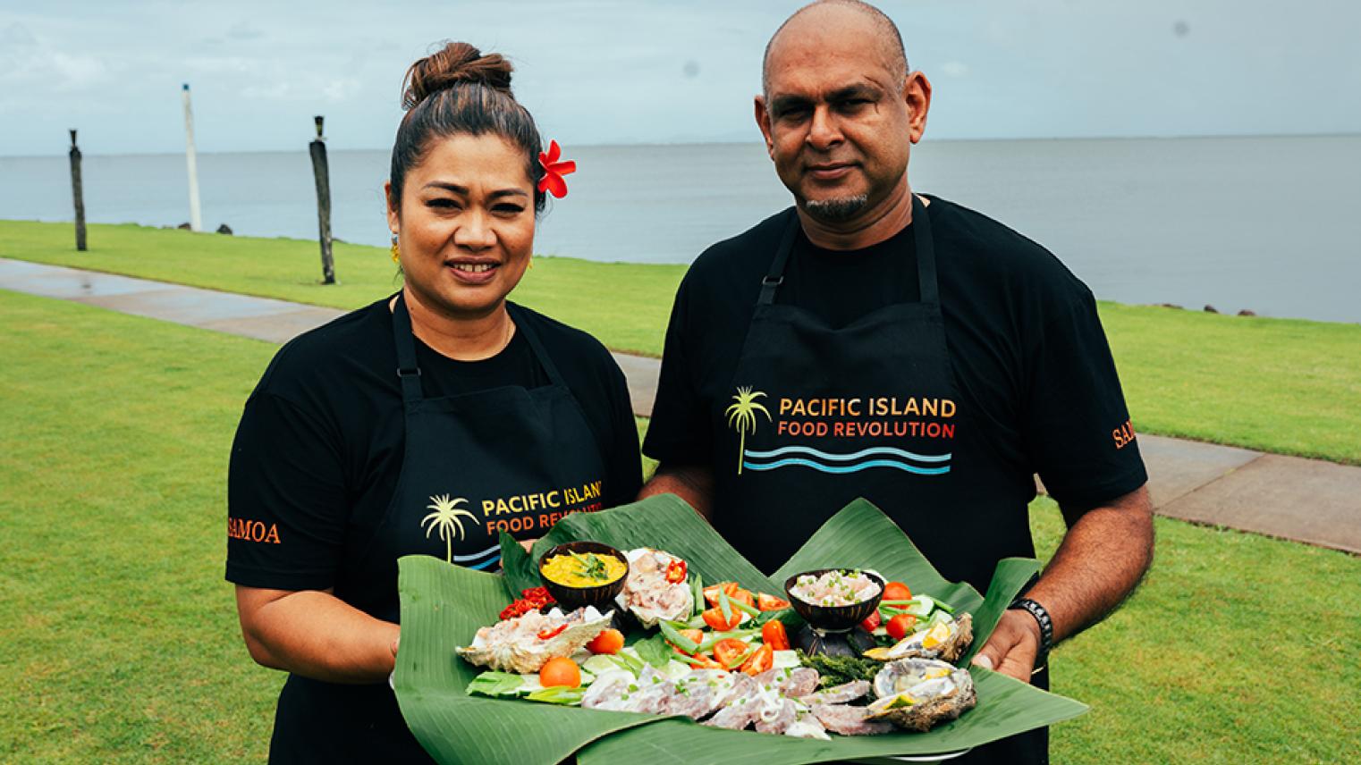 TV hosts holding food image by Pacific Island Food Revolution